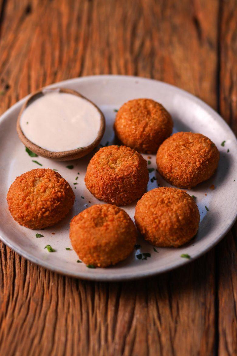 O bolinho, tradicional na cozinha árabe e bastante procurado,  está disponível no Samir Amis que destaca, em seu cardápio, o falafel de grão de bico. Assim como as demais especiarias do menu, é uma receita familiar e traz consigo uma bagagem repleta de histórias e lembranças desde a fundação do empório. Pimenta, cominho e o grão de bico - curado na água durante 12 horas -,  dão um toque extra no prato, que é servido acompanhado de tahine e coalhada fresca para acentuar toda sua composição.